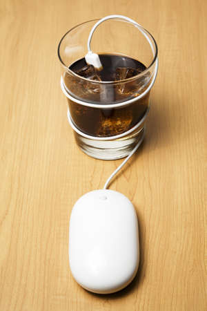 Computer mouse connected to cocktailの写真素材