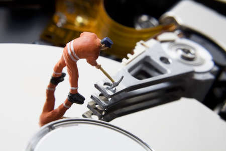 Worker figurine on hard driveの写真素材