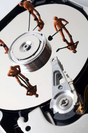 Worker figurine on hard drive