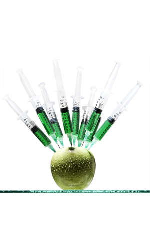 Syringes stuck in an apple の写真素材