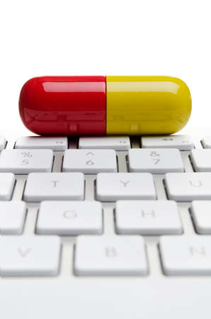 Giant pill on a computer keyboard