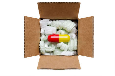 Large pill in a box with packaging peanuts