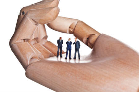 Artificial hand holding business figurinesの写真素材
