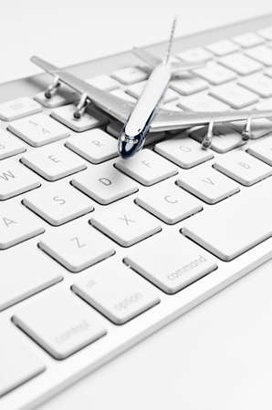 Toy jet airliner on a computer keyboardの写真素材