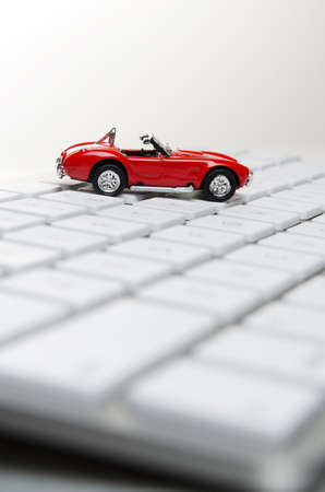 Toy car on a computer keyboard