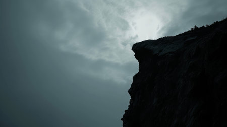 rock cliff edge stand alone against a cloudy sky mountain with gray sky AI generatedの素材