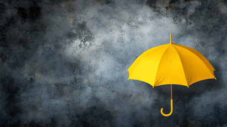 A vibrant yellow umbrella stands alone against a stormy gray sky, creating a striking contrast. This image symbolizes protection and brightness amid gloomy weather.の素材