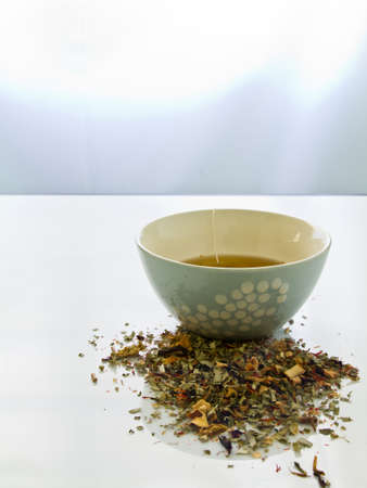 Cup of herbal tea on white table の写真素材