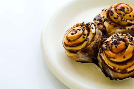 Cocolated and sesame bun on dishの写真素材