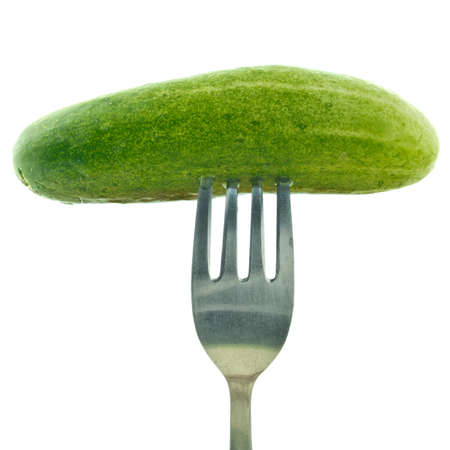 Fork stuck in cucumber isolated on white backgroundの写真素材