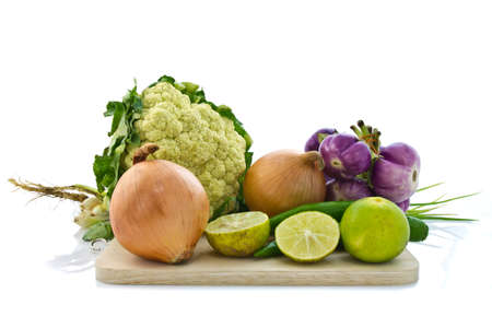 Various kinds of vegetable on chopping board isolated on whiteの写真素材