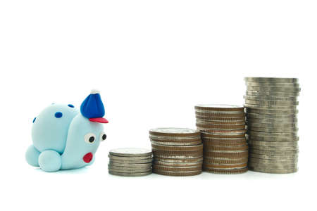 Heap of coins and plasticine turtle for financial planning conceptの写真素材
