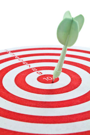 Green dart on red dart boardの写真素材