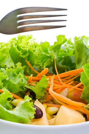 Salad in white bowl with forkの写真素材