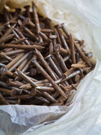 Rusty nails in old plastic bagの写真素材