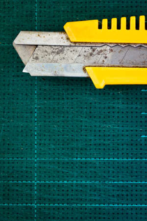 Rusty cutter and old cutting rubber matの写真素材