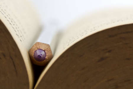 Closeup of pencil on old bookの写真素材