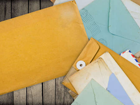 Old envelopes on wood with spcae for contact information or others messageの写真素材