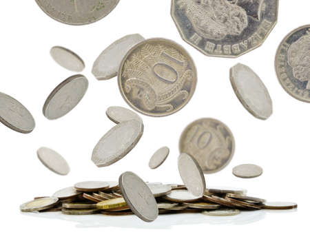 Coins falling with pile of moneyの写真素材