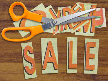 Sale in cut letters with scissors for discount conceptの写真素材