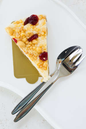 Scrambled chesse cake on white plate