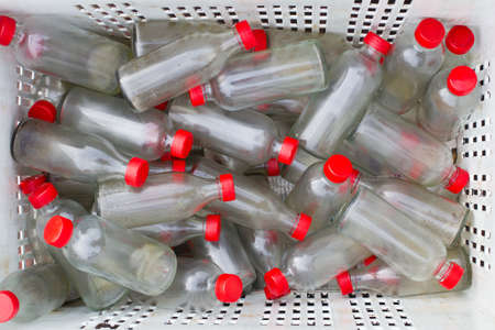 Old bottles in the basket for recycleの写真素材