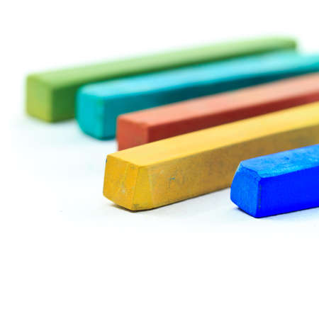 Closeup of pastel sticks on white paper