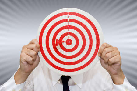 Businessman show the dart and target accuracy