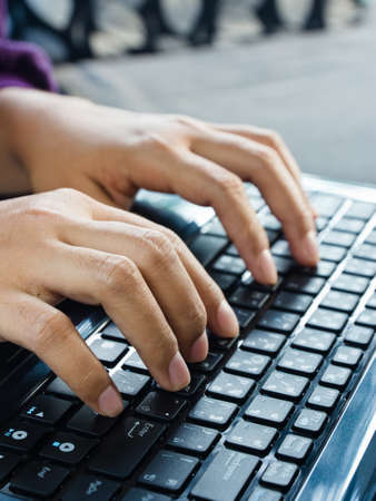Finger typing on laptop keyboard