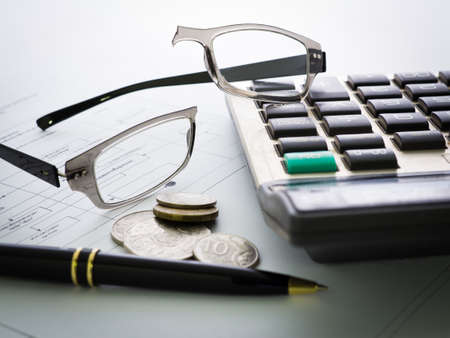 Broken eyeglasses on business deskの写真素材