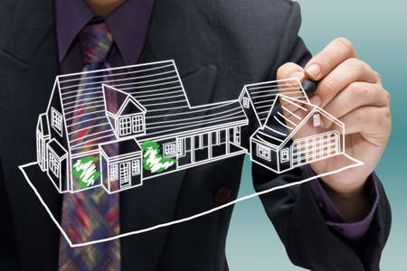 Businessman sketching house modelの写真素材