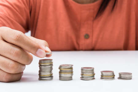 Hand add a coin on a heap