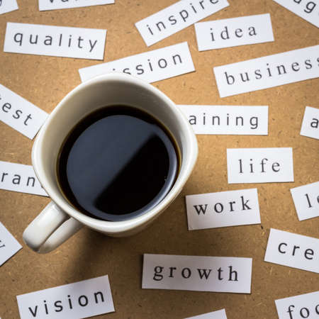 Black coffee with papers of business keyword on the deskの写真素材