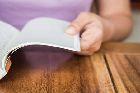 Closeup hand open book for reading concept backgroundの写真素材