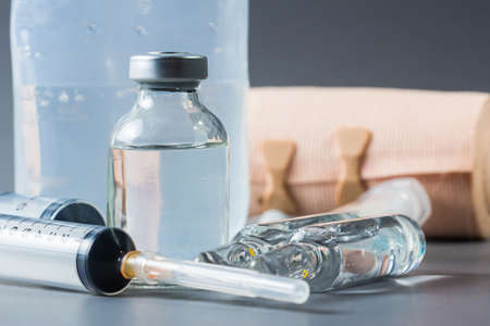 Vials and medical equiments on gray backgroundの写真素材