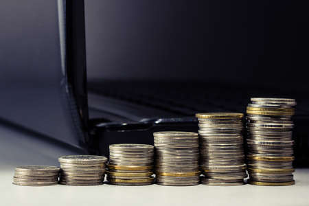 Coins stair and computer laptopの写真素材