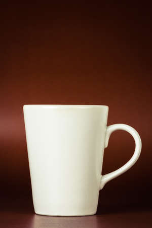 Ceramic cup on dark red backgroundの写真素材