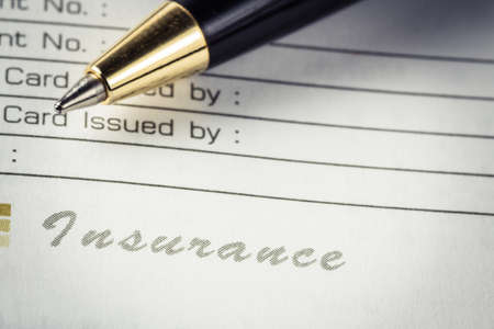 Closeup insurance word on organizer notebook with penの写真素材