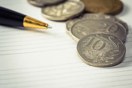 Coins on empty page of personal organizerの写真素材