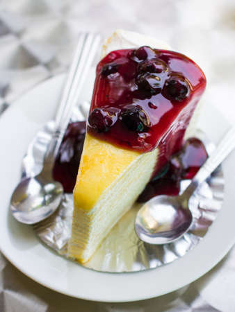 Blue berry cheese cake on dish with two spoons