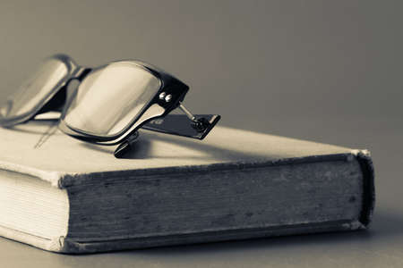 Eyeglasses and old book in vintage color