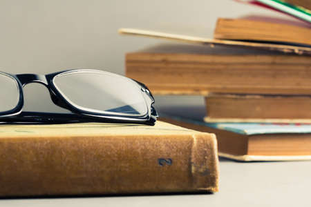 Eyeglasses and old used books