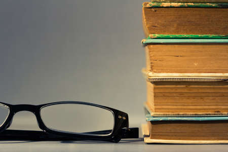 Eyeglasses and stack of used books