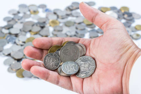 Closeup coins in hand for financial or investment conceptの写真素材