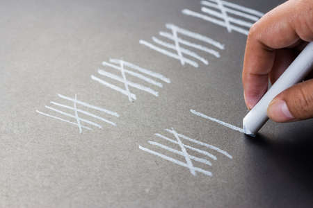 Hand counting with chalk marksの写真素材