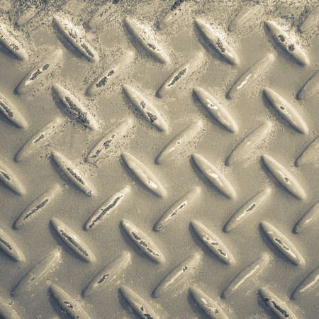 Checker plate metal with rust stain in monotone colorの写真素材