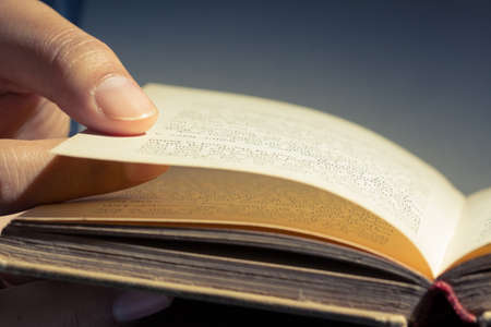 Closeup finger on the old book for reading conceptの写真素材