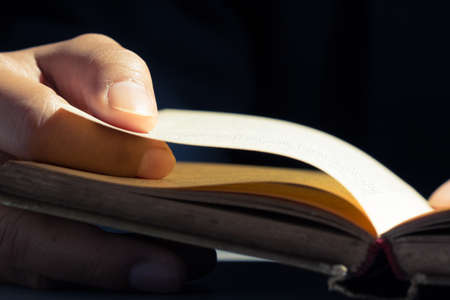 Closeup finger on the old book for reading conceptの写真素材