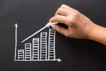 Hand drawing success graph with chalkの写真素材