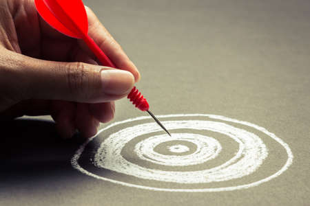 hand going to take dart into the center of sketching dartboard hand going to take dart into the center of sketching dartboard